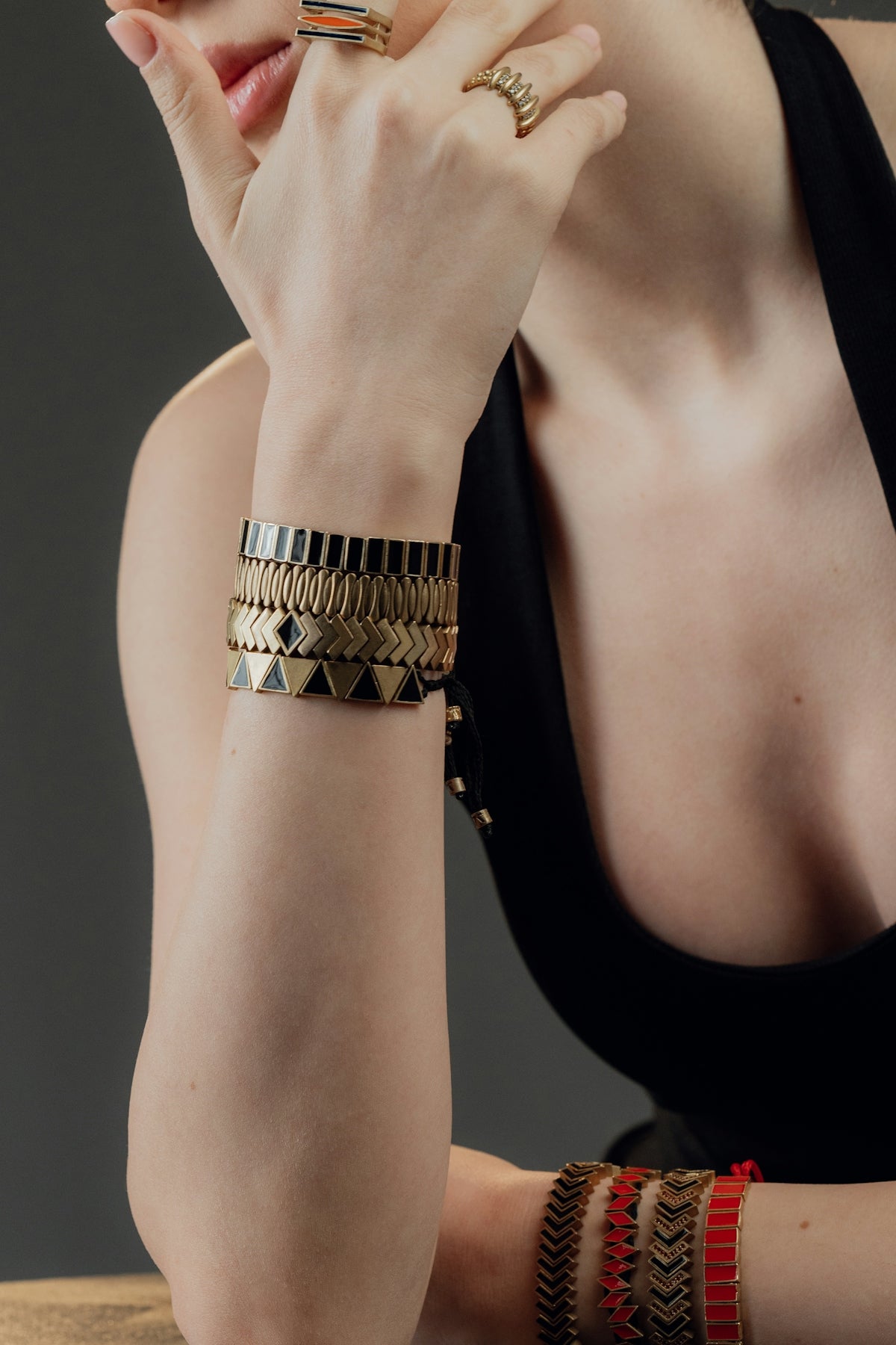 Woman wearing stacked bracelets and rings