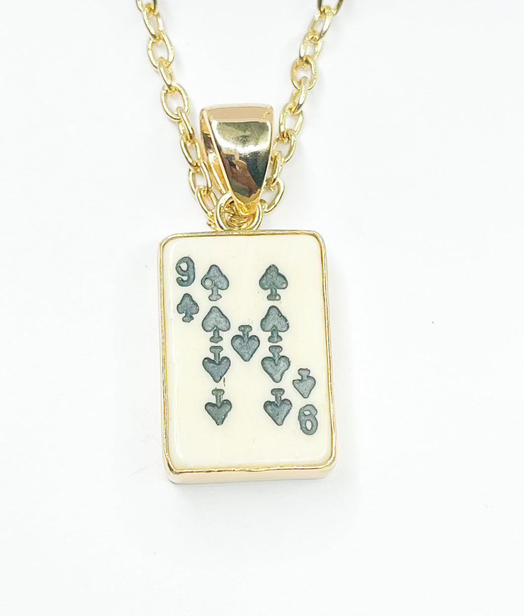 Load image into Gallery viewer, 9 Of Spades Bone Card Pendant - Alchemia
